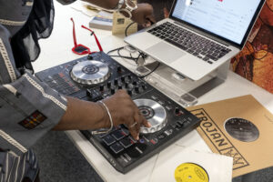 Close up shot of a black woman operating music mixing equipment